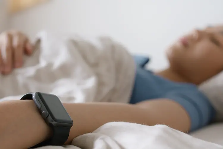 Person wearing a smartwatch while sleeping